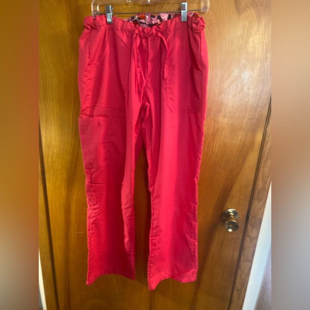 Ladies “WEAR FOR CARE” pink medical scrubs.